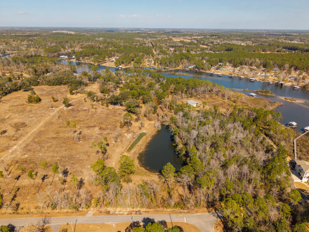 land, water, aerial view of wooded waterfront property and homesites along Wolf Creek in South Alabama