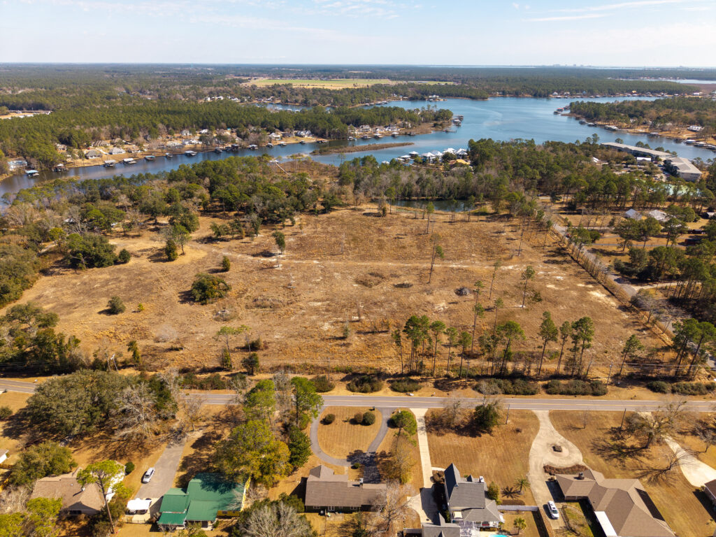 land, water, aerial view of wooded waterfront property and homesites along Wolf Creek in South Alabama