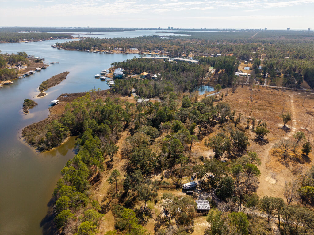 land, water, aerial view of wooded waterfront property and homesites along Wolf Creek in South Alabama